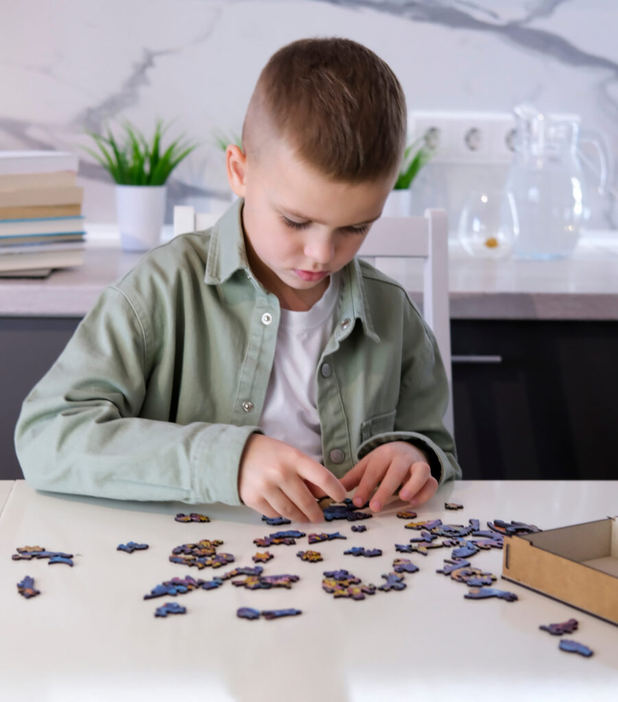 Kinder und Erwachsenen haben Spaß beim Legen von Puzzles (AdobeStock/Inna)